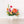 small flower arrangement with orange pink and yellow flowers on table